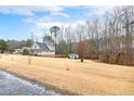 A picturesque view of the house with a well-manicured lawn and a storage shed in the background at 3208 Westchester Dr, Sanford, NC 27330