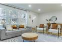 Bright and airy living room showcasing natural light, modern furniture, and a patterned rug at 711 Horton Rd, Durham, NC 27704