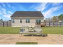 Spacious backyard with a wooden bench on a stone patio, perfect for outdoor relaxation and entertaining at 95 Southern Pl, Lillington, NC 27546