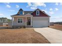 Attractive two-story house with a well-maintained lawn, attached garage, and inviting front entrance with an American flag at 95 Southern Pl, Lillington, NC 27546