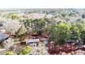 Aerial view of a house nestled among dense trees showcasing privacy and spacious land at 1118 Cool Springs Rd, Sanford, NC 27330