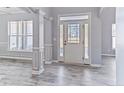 Bright entryway with a front door flanked by sidelights and lovely molding and gray laminate floors at 131 Southbrook Ln, Sanford, NC 27332