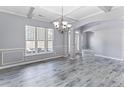 Bright open living room with luxury vinyl plank flooring, neutral paint, and traditional details at 131 Southbrook Ln, Sanford, NC 27332