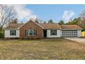 Lovely single-story home featuring a brick and siding exterior, well-kept lawn, and an attached two-car garage at 1425 Ponderosa Trl, Cameron, NC 28326