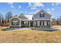 Inviting home with a mix of stone and siding, complemented by professionally landscaped front yard at 208 Planters Ln, Coats, NC 27521