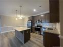 Modern kitchen featuring stainless steel appliances, granite countertops, and a center island at 240 Gallery Dr # 201, Spring Lake, NC 28390