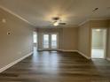 Spacious living room with hardwood floors, ceiling fan, and access to a patio at 240 Gallery Dr # 201, Spring Lake, NC 28390