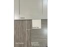A curated selection of vinyl flooring, gray tile surround, white quartz top, and white cabinet at 265 Harborwood St, Lillington, NC 27546