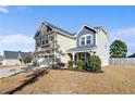 Charming two-story home with a three-car garage and inviting front porch at 38 Heatherwood Dr, Lillington, NC 27546