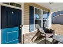 Inviting front porch with a blue door and a chair at 38 Heatherwood Dr, Lillington, NC 27546