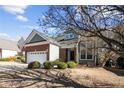 Lovely home with green siding and a brick garage, complemented by mature landscaping at 98 Cottswold Ln, Spring Lake, NC 28390