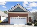 Close-up of the brick two-car garage showcasing its architectural details at 98 Cottswold Ln, Spring Lake, NC 28390