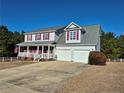 Two-story home with a covered porch, two-car garage, and well-maintained lawn at 11 Scotland Dr, Spring Lake, NC 28390