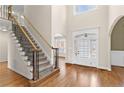 Bright foyer with hardwood floors, staircase, and arched doorway at 127 Skipping Water Dr, Spring Lake, NC 28390