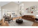 Open living room with high ceilings, fireplace, and seamless flow into the kitchen at 127 Skipping Water Dr, Spring Lake, NC 28390