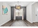 Dining room with wainscoting, wood floors, an updated chandelier, neutral paint and plenty of light at 137 Virginia Pine Dr, Cameron, NC 28326