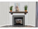 Living room fireplace with shiplap surround, dark wood mantel, artwork, and gray hexagonal tile at 137 Virginia Pine Dr, Cameron, NC 28326