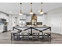 New kitchen with white cabinets, a black and white island with seating, and stainless steel appliances at 137 Virginia Pine Dr, Cameron, NC 28326