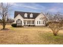 Inviting two-story home featuring a covered front porch, classic black shutters, and a spacious front yard at 302 Mar Joy Dr, Dunn, NC 28334