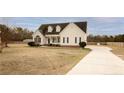 Two-story home with covered front porch, symmetrical facade, long driveway, and spacious front lawn at 302 Mar Joy Dr, Dunn, NC 28334