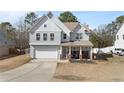 Beautifully maintained two-story home with a manicured lawn and attached garage at 334 Heathrow Dr, Spring Lake, NC 28390