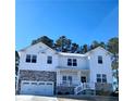 Charming two-story home featuring a covered porch, a two-car garage, and a well-maintained front yard at 38 Cedarview Ct, Cameron, NC 28326