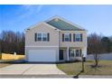 Lovely two-story home featuring a well-manicured lawn, a driveway, and an attached two-car garage at 131 Archer Dr, Bunnlevel, NC 28323