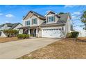 Charming two-story home with a well-manicured lawn and attached two-car garage at 219 Regimental Dr, Cameron, NC 28326