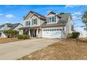 Charming two-story home featuring a two-car garage and welcoming front porch at 219 Regimental Dr, Cameron, NC 28326