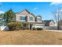 Charming two-story home with a well-manicured lawn and attached two-car garage at 219 Regimental Dr, Cameron, NC 28326