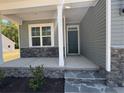 Inviting front porch with stone accents, stylish columns, and a well-maintained entryway to the home at 22 Peach Orchard (Lot 1) Ln, Lillington, NC 27546