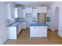 Bright kitchen featuring white cabinets, an island, and light-colored countertops at 22 Peach Orchard (Lot 1) Ln, Lillington, NC 27546