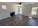Bright living room with a fireplace, hardwood floors and ample natural light from multiple windows at 22 Peach Orchard (Lot 1) Ln, Lillington, NC 27546