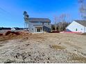 Back of a two-story house with gray siding and a sliding glass door at 22 Peach Orchard (Lot 1) Ln, Lillington, NC 27546