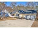 Exterior view showing the spacious driveway and well-maintained facade of this charming home at 273 Coachman Way, Sanford, NC 27332