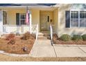 Welcoming front porch with a charming entryway, tidy landscaping, and classic design at 273 Coachman Way, Sanford, NC 27332