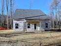 New home featuring windows, doors, and covered porch during the final construction stages at 62 Peach Orchard (Lot 3) Ln, Lillington, NC 27546