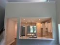 Open concept: kitchen has granite counter space with a view into the living area at 62 Peach Orchard (Lot 3) Ln, Lillington, NC 27546