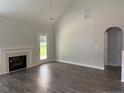 Bright living room featuring vaulted ceiling, fireplace, and sleek, hard surface flooring at 62 Peach Orchard (Lot 3) Ln, Lillington, NC 27546