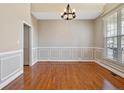 Bright dining room with hardwood floors, decorative molding, and a modern light fixture at 147 Lamplighter Way, Spring Lake, NC 28390