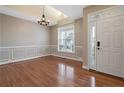 Elegant dining area with hardwood floors, wainscoting, and a double door entrance at 147 Lamplighter Way, Spring Lake, NC 28390