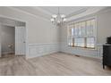 Bright dining room with detailed trim, chandelier, and a large window for natural light at 45 Cutter Cir, Sanford, NC 27332
