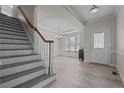 Bright foyer showcasing staircase, elegant chandelier, and pristine hardwood floors; a welcoming entrance at 45 Cutter Cir, Sanford, NC 27332
