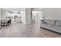 Bright, open-concept living space with hardwood floors, modern finishes, and staircase at 45 Cutter Cir, Sanford, NC 27332