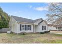 Cozy single-Gathering home with an attached garage, vinyl siding, and manicured lawn at 7383 Elliott Bridge Rd, Spring Lake, NC 28390