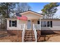 Close-up of the front entrance featuring a white door and complementary railings and brick foundation at 14 Brafford Estates Dr, Cameron, NC 28326