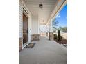 Inviting front porch with stone accents and a welcoming entryway at 202 Heatherwood Dr, Lillington, NC 27546