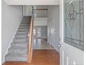 Bright foyer with hardwood and tile flooring, staircase, and view to the living area at 25 Trenton Place, Cameron, NC 28326