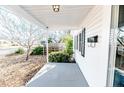 Covered front porch with classic design elements, a white railing and concrete floor at 802 E Canary St, Dunn, NC 28334