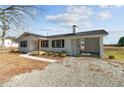 Beautifully renovated home with a carport, featuring a white brick facade and dark roof at 860 Main St, Lillington, NC 27546